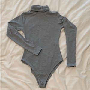 Pretty Little Things grey turtleneck body suit